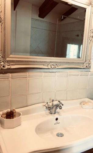 a bathroom sink with a mirror and a sink at Hotel Abaco Altea in Altea