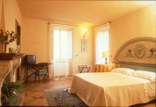 a bedroom with a bed and a television in it at Locanda di Porta Antica in San Benedetto del Tronto