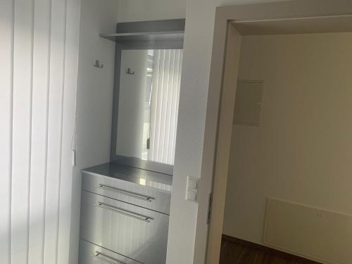 a kitchen with a sink and a mirror at Hotel Am Spielacker in Gelnhausen