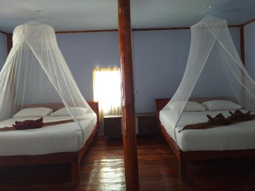 Postel nebo postele na pokoji v ubytování Kohjum Relax Beach