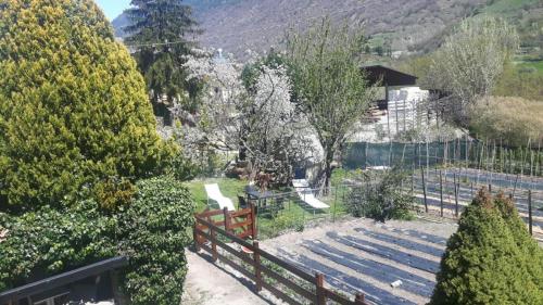 a person sitting on a bench next to a fence at Casa Vacanze Germano in Aosta