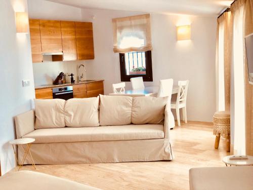 a living room and kitchen with a couch and a table at Hotel Abaco Altea in Altea