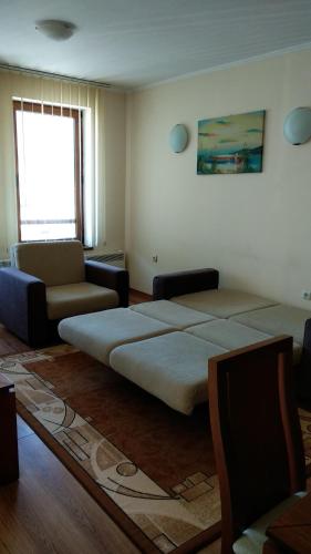 a living room with a large bed and a couch at Ski Apartment D50 Cedar Lodge 4 in Bansko