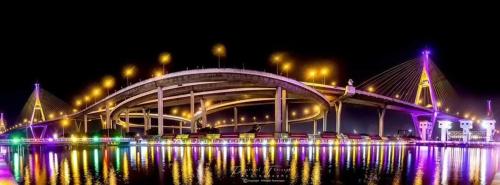 a bridge over a body of water at night at 88 Homestay in Bang Chak