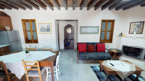 a kitchen and living room with a table and chairs at Stou Kir Yianni in Omodos