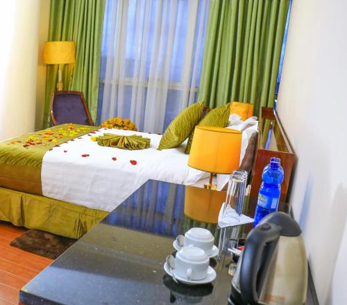a bedroom with a bed and a table with a phone at Denver boutique hotel in Addis Ababa