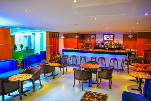 a restaurant with tables and chairs and a bar at Denver boutique hotel in Addis Ababa