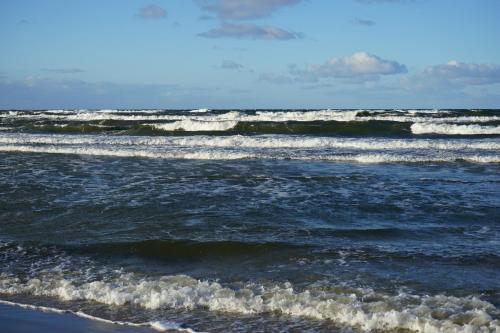 a group of breaking waves in the ocean at Hotel White in Krynica Morska