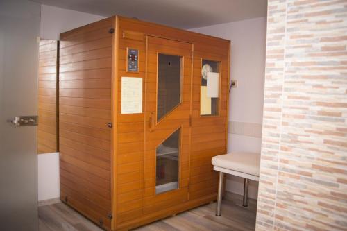 a room with a wooden wall with a bench and a door at Noviz Hotel in Plovdiv