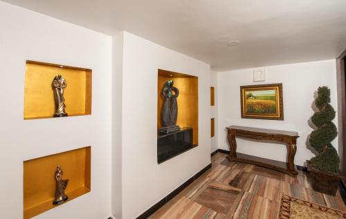 a hallway with art on the walls at Shoolin Resorts in Manipala