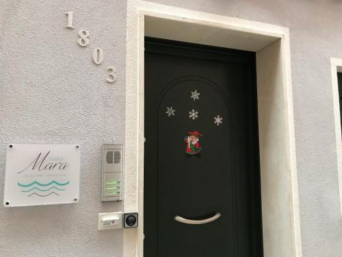a black door with a christmas sticker on it at Casa Mara in Chioggia