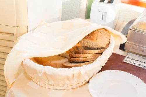 a basket of bread sitting on a table at Noviz Hotel in Plovdiv