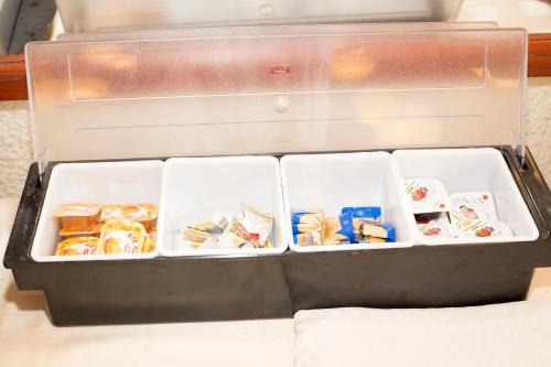 an open refrigerator with food inside of it at Noviz Hotel in Plovdiv