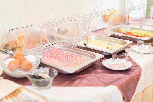 a table with three trays of food on it at Noviz Hotel in Plovdiv
