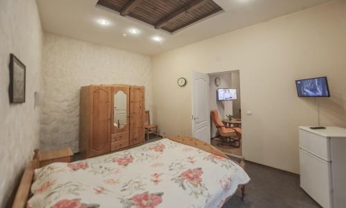 a bedroom with a bed and a dresser in it at Leo in Daugavpils