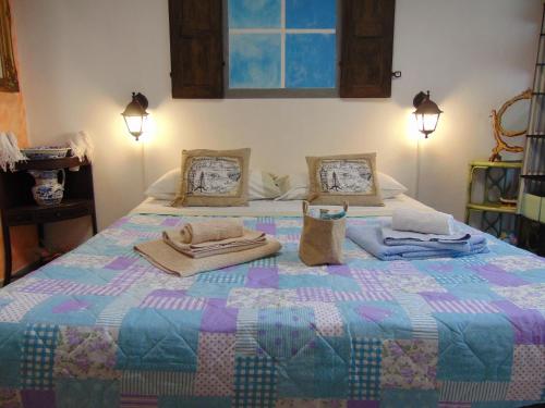 a bedroom with a bed with a quilt on it at Da Sara e Paolo in Viareggio