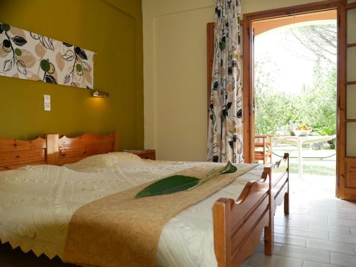 een slaapkamer met een bed en een groot raam bij Marios Studios in Sidari
