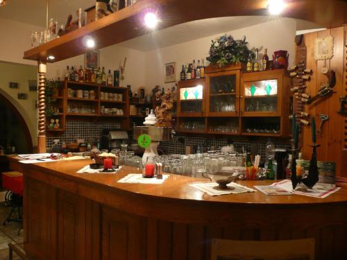 a bar with a large wooden counter in a room at Penzion U Urbanů in Němčice
