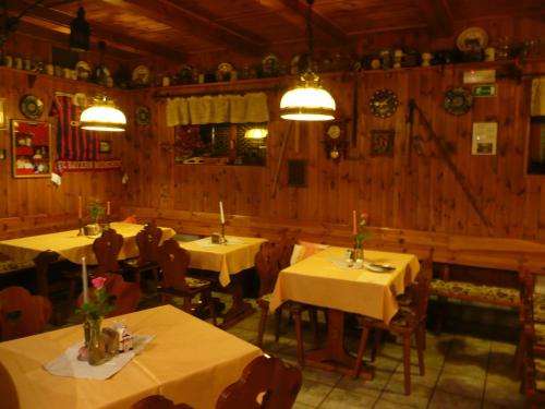 a dining room with tables and chairs in a restaurant at Penzion U Urbanů in Němčice