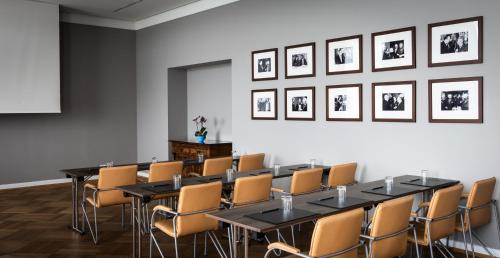 a meeting room with a long table and chairs at AMERON Bonn Hotel Königshof in Bonn