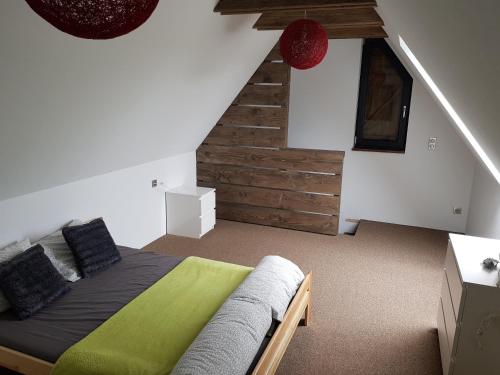 a bedroom with a bed and a stair case at Osada Knurów in Knurów