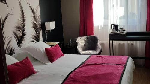 a bedroom with a bed with pink pillows and a chair at Hotel de Champagne in Épernay