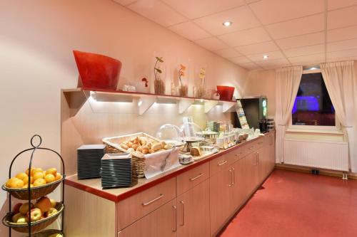 a kitchen with a long counter with food on it at meinHotel in Hamburg