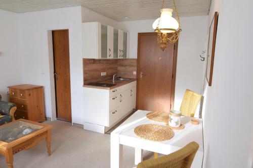 uma cozinha com uma mesa branca e um lavatório em Haus Maria Elisabeth em Mittenwald