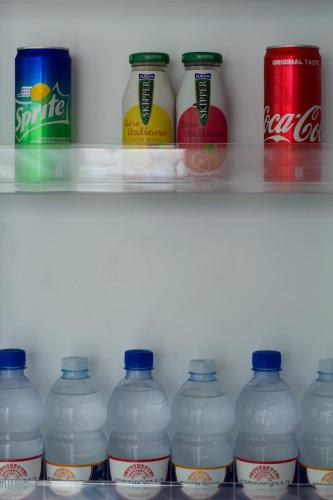 a refrigerator filled with lots of bottles of water at La Terrazza di Eraclea in San Leone
