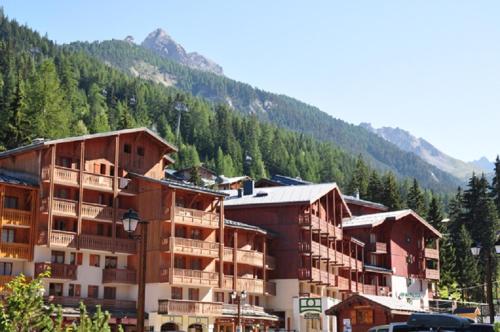 a group of buildings in front of a mountain at Les Melezets 1 in Valfréjus