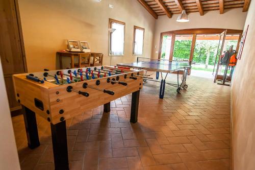 a game room with a table and a foosball at Particolari del Brenta in Oriago Di Mira