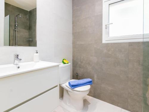 a bathroom with a toilet and a sink and a mirror at Apartment Velazquez-5 by Interhome in Roses