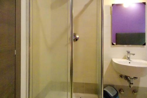 a bathroom with a shower and a sink at Hotel Midtown Milano in Milan