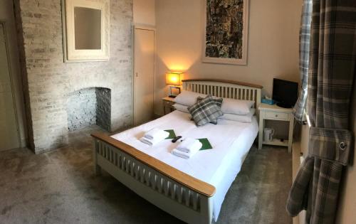 una camera da letto con un grande letto e un camino di Galtres Lodge Hotel & Forest Restaurant a York