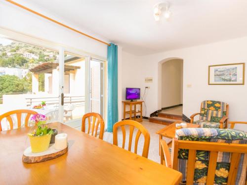 a living room with a table and chairs and a couch at Apartment Velazquez-4 by Interhome in Roses