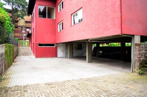 a red building on a brick street at Pousada Tango in Gramado