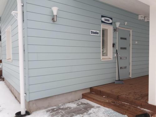 a front door of a house with a sign on it at Vuokatti Slope Studio in Vuokatti
