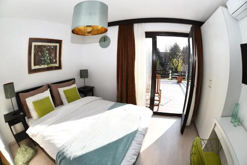 a bedroom with a bed and a large window at MonikaRooms in Zagreb