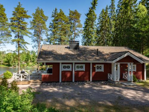 a red carriage house with a garage at Holiday Home Kivitasku by Interhome in Hirsjärvi