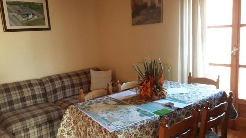 a living room with a table and a couch at Casa Vacanze Germano in Aosta