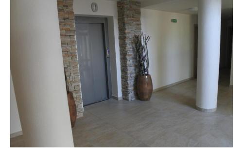 a hallway with two vases sitting next to a door at Apartmán v Starej Lesnej s balkónom in Stará Lesná