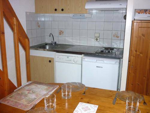 a kitchen with a wooden table and a sink at Holiday Home Paradise Océan-5 by Interhome in Capbreton