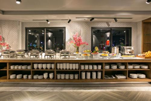 a buffet with a lot of food on display at AVORA Boutique Hotel in Da Nang