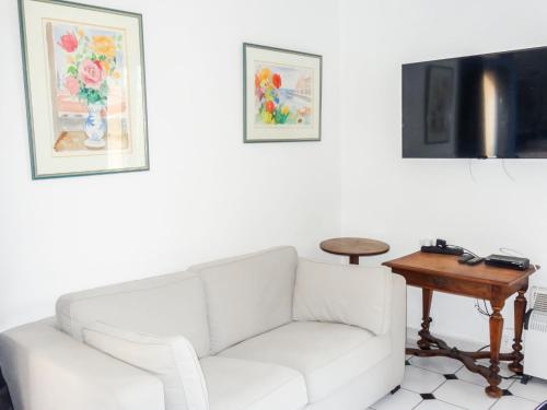 een woonkamer met een witte bank en een tafel bij Holiday Home Le Vent d'Est by Interhome in Saint-Tropez