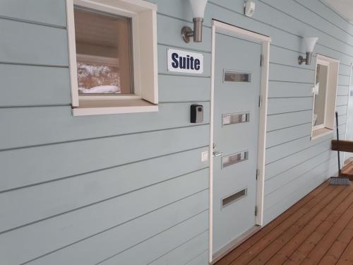 a door to a house with a smile sign on it at Vuokatti Slope Suite in Vuokatti