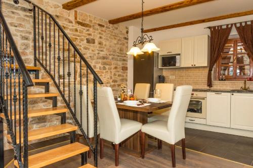 a kitchen and dining room with a table and chairs at Villa Andrija in Šibenik