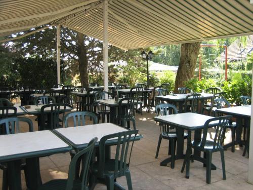 a group of tables and chairs under a tent at Motel Le Léman in Commugny