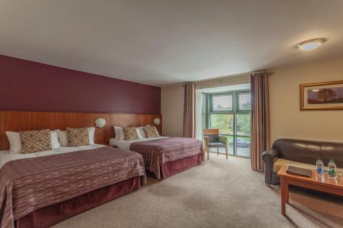a hotel room with two beds and a window at Silverbirch Hotel in Omagh