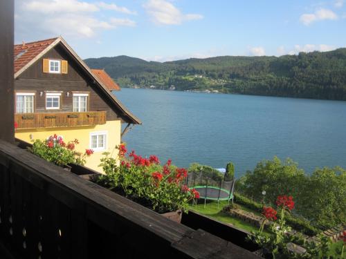 a house with a view of a lake at Pension Sedlak in Millstatt
