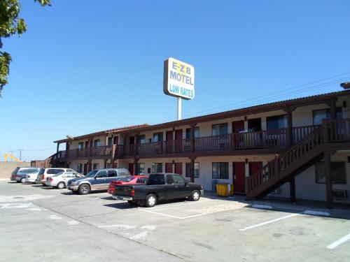 a hotel with cars parked in a parking lot at EZ 8 Motel Newark in Newark